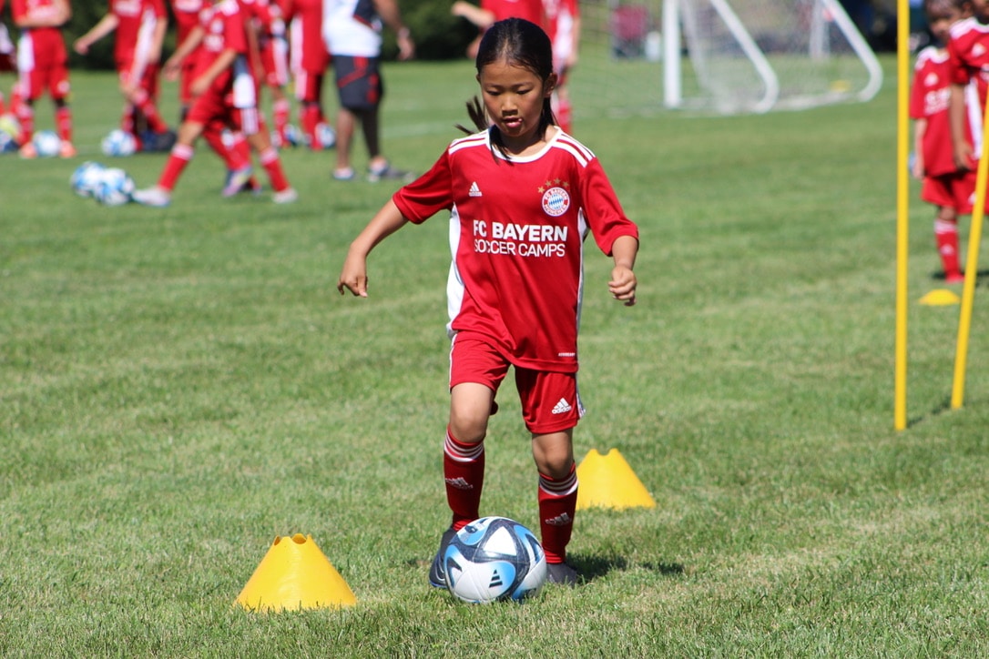 A girl performing a soccer drill to improve ball control