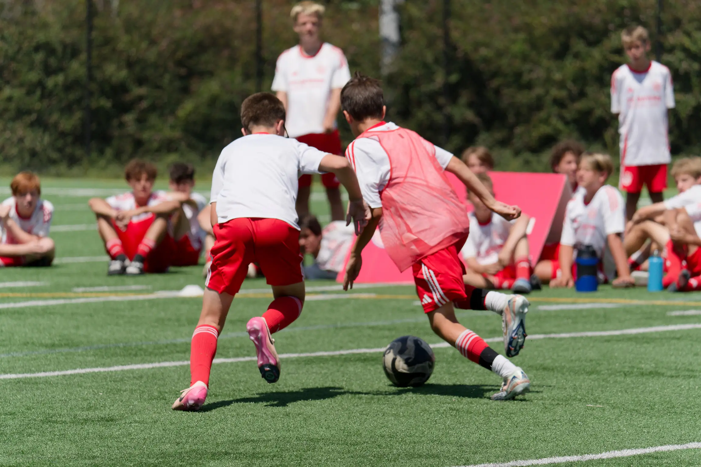 Boys are playing and learning about youth soccer positions during a game.